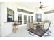 Covered patio with bar seating, ceiling fan, and a table set for six offers the perfect entertaining spot at 1311 Fallsmeade Ct, Oldsmar, FL 34677