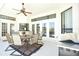 Outdoor kitchen with dining area, ceiling fan, and easy access to the backyard, ideal for grilling and entertaining at 1311 Fallsmeade Ct, Oldsmar, FL 34677