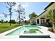 Backyard oasis featuring a pool, spa, and a view of the lush green golf course, perfect for relaxation and recreation at 1311 Fallsmeade Ct, Oldsmar, FL 34677