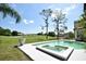 The inviting backyard features a pool, spa, and scenic golf course view for relaxing and enjoying the outdoors at 1311 Fallsmeade Ct, Oldsmar, FL 34677