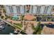 Aerial view of waterfront condo community showcasing swimming pool, boat docks, and lush landscaping at 1325 Snell Isle Ne Blvd # 607, St Petersburg, FL 33704