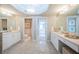 Bright bathroom with dual vanity, marble floors, and access to a private toilet and a bedroom at 1325 Snell Isle Ne Blvd # 607, St Petersburg, FL 33704
