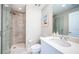 Modern bathroom featuring a walk-in shower, vanity with white cabinets, and white walls and floors at 1325 Snell Isle Ne Blvd # 607, St Petersburg, FL 33704