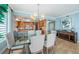 Elegant dining area, featuring a glass table, modern lighting, and a glimpse into the well-equipped kitchen at 1325 Snell Isle Ne Blvd # 607, St Petersburg, FL 33704