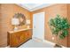 Elegant hallway showcasing a wood cabinet, lamps, mirror and a tall leafy plant at 1325 Snell Isle Ne Blvd # 607, St Petersburg, FL 33704
