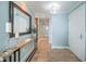 Inviting hallway with light blue walls, tile flooring, and decorative console table with a mirror at 1325 Snell Isle Ne Blvd # 607, St Petersburg, FL 33704