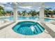 Relaxing hot tub and sparkling swimming pool surrounded by palms and a white pergola offering shaded seating at 1325 Snell Isle Ne Blvd # 607, St Petersburg, FL 33704