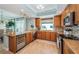 Kitchen features wood cabinets, granite countertops, a wine cooler, and stainless-steel appliances at 1325 Snell Isle Ne Blvd # 607, St Petersburg, FL 33704
