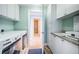 Functional laundry room with white cabinets, sink, and a view into the ensuite bathroom at 1325 Snell Isle Ne Blvd # 607, St Petersburg, FL 33704