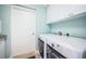 Bright laundry room featuring a washer and dryer, white cabinets, and a door to the outside at 1325 Snell Isle Ne Blvd # 607, St Petersburg, FL 33704