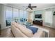 Inviting living room featuring a cozy couch, ceiling fan, and a balcony with stunning waterfront views at 1325 Snell Isle Ne Blvd # 607, St Petersburg, FL 33704