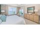 Comfortable bedroom featuring water views, a cozy chair, and a mirrored dresser at 1325 Snell Isle Ne Blvd # 607, St Petersburg, FL 33704