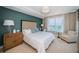 Serene bedroom with a large window, tufted headboard and soothing blue accent wall at 1325 Snell Isle Ne Blvd # 607, St Petersburg, FL 33704