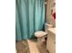 Cozy bathroom with a blue shower curtain, white toilet, and a small vanity at 1370 Heather Ridge Blvd # 310, Dunedin, FL 34698