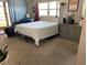 Bright bedroom features large window, dresser, and access to a balcony with lots of light at 1370 Heather Ridge Blvd # 310, Dunedin, FL 34698