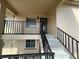 Exterior of the building showing the entrance, stairs and railing at 1370 Heather Ridge Blvd # 310, Dunedin, FL 34698