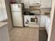 Features bright kitchen appliances and neutral tiled floors at 1370 Heather Ridge Blvd # 310, Dunedin, FL 34698