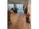 Spacious living room with mirrored wall, access to balcony and comfortable seating at 1370 Heather Ridge Blvd # 310, Dunedin, FL 34698