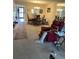 Neutral-toned living room with a rug, comfortable seating, and a view into dining area at 1370 Heather Ridge Blvd # 310, Dunedin, FL 34698
