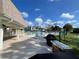 Outdoor pool area with lounge chairs and umbrellas, perfect for relaxation and socializing at 1370 Heather Ridge Blvd # 310, Dunedin, FL 34698