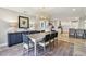 Dining room open to modern kitchen, with white cabinets and stainless steel appliances at 1391 50Th Ne Ave, St Petersburg, FL 33703