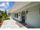 A charming home entrance with a patterned tile landing, a vibrant wreath on the blue door, and stylish outdoor lighting at 1391 50Th Ne Ave, St Petersburg, FL 33703