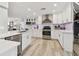 Bright, remodeled kitchen with white cabinets, stainless appliances and bar seating open to living space at 1391 50Th Ne Ave, St Petersburg, FL 33703