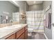 Bathroom with vanity, sink, toilet, and shower with striped curtain at 1418 Rushgrove Cir, Dover, FL 33527