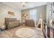 Bedroom featuring a crib, changing table, teepee, and wood-look floors at 1418 Rushgrove Cir, Dover, FL 33527