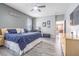 Primary bedroom suite features ceiling fan, dresser, TV, and grey walls at 1418 Rushgrove Cir, Dover, FL 33527