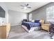 Bedroom boasts ceiling fan, TV, and neutral decor at 1418 Rushgrove Cir, Dover, FL 33527