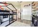 A bedroom featuring a bunk bed, closet, shelves, and modern wood-look floors at 1418 Rushgrove Cir, Dover, FL 33527