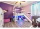 Whimsical bedroom with a unique house frame bed featuring a slide, perfect for a imagination and play at 1418 Rushgrove Cir, Dover, FL 33527