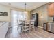 Dining area adjacent to the kitchen with modern lighting and a sliding door to the outside at 1418 Rushgrove Cir, Dover, FL 33527