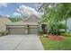 Charming single-story home with a three-car garage and beautifully landscaped front yard at 1418 Rushgrove Cir, Dover, FL 33527