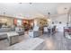 Open living space with modern decor, wood floors, kitchen island, and dining area at 1418 Rushgrove Cir, Dover, FL 33527