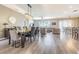 Open-concept living space with a dining area, living room, and hardwood floors throughout at 1418 Rushgrove Cir, Dover, FL 33527