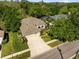 Beautiful home with a well-manicured lawn, mature landscaping, and a wide driveway leading to a three-car garage at 15254 Bellamy Rd, Tampa, FL 33625