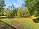 Expansive backyard surrounded by lush greenery, providing a private and serene outdoor space at 15254 Bellamy Rd, Tampa, FL 33625
