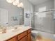 Bathroom featuring tile flooring, a glass shower door and a wood vanity at 15254 Bellamy Rd, Tampa, FL 33625
