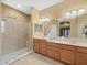 Bathroom with tiled shower, double sink vanity, and neutral color palette throughout at 15254 Bellamy Rd, Tampa, FL 33625