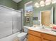 Green bathroom features combination shower and tub at 15254 Bellamy Rd, Tampa, FL 33625