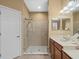 Bathroom featuring glass enclosed shower, single sink vanity and neutral color palette at 15254 Bellamy Rd, Tampa, FL 33625
