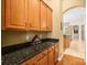 Spacious butler's pantry features granite countertop and wood cabinets at 15254 Bellamy Rd, Tampa, FL 33625