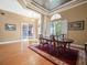 Formal dining area featuring hardwood floors, modern lighting, and classic decor at 15254 Bellamy Rd, Tampa, FL 33625