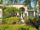 Inviting entrance with manicured landscaping, arched entryway, and decorative front door at 15254 Bellamy Rd, Tampa, FL 33625