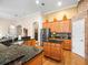 Spacious kitchen featuring granite countertops, stainless steel appliances, and wood cabinetry at 15254 Bellamy Rd, Tampa, FL 33625
