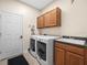 Laundry room equipped with sink, cabinets, washer and dryer at 15254 Bellamy Rd, Tampa, FL 33625