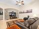Comfortable living room with large TV, tile floors, and neutral paint at 15254 Bellamy Rd, Tampa, FL 33625