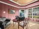 Office featuring a large desk, dark leather couch and two windows with white shutters at 15254 Bellamy Rd, Tampa, FL 33625